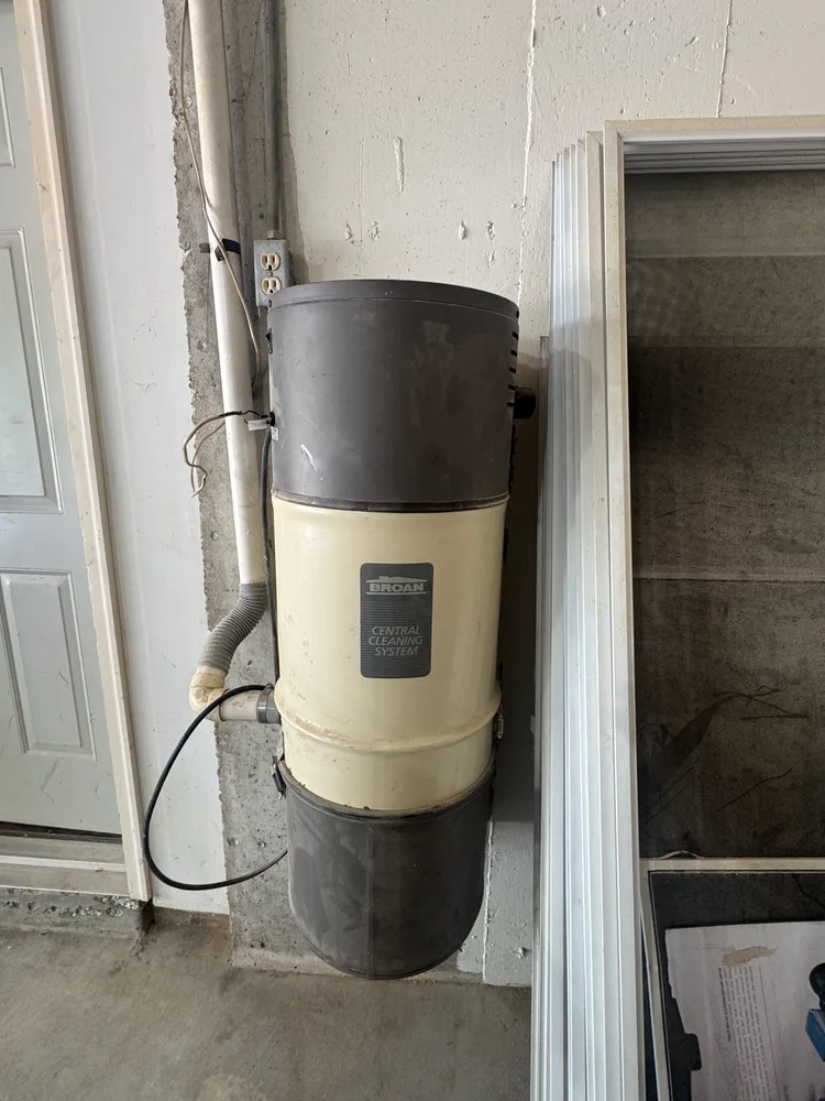 Cream and dark-colored Broan central vacuum power unit