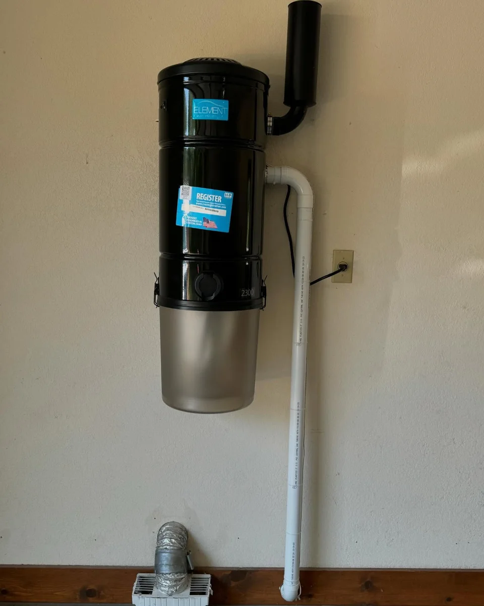 Wall-mounted central vacuum power unit and piping