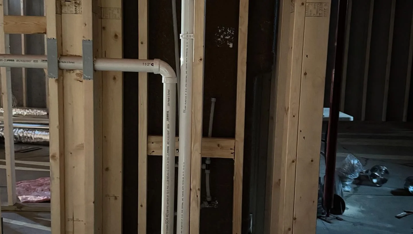 Central vacuum tubing routed through wall studs on a Vac Shack job