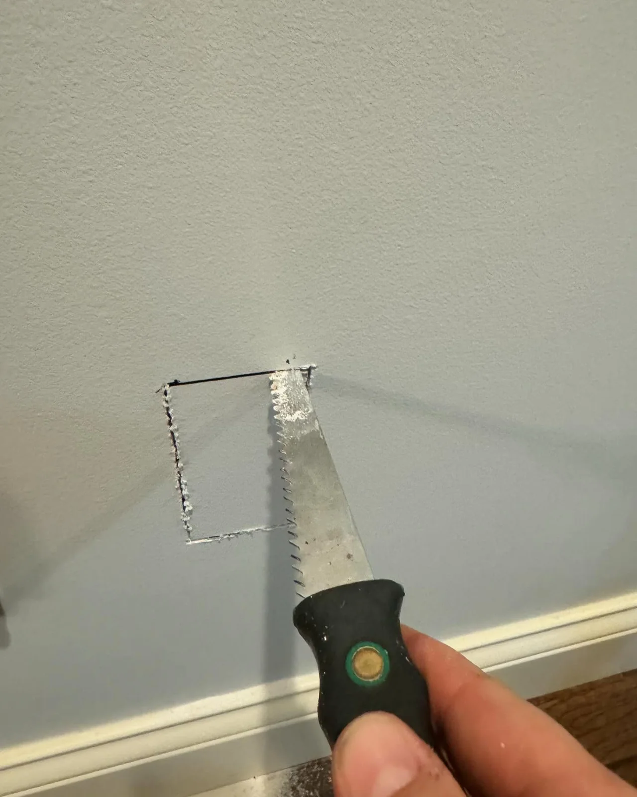 Wall opening exposing central vacuum piping